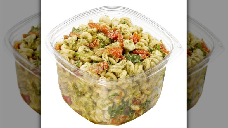 A container of Kirkland Signature Pesto Pasta Salad with Mozzarella Pearls and Italian Pesto