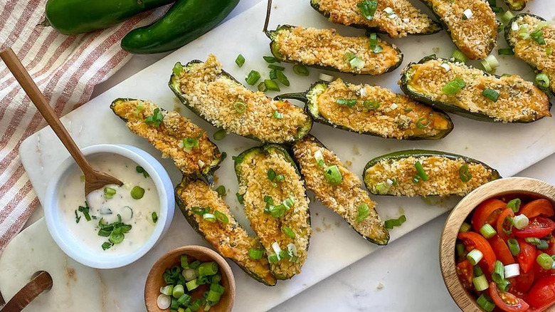 Air Fryer Jalapeño Poppers on white board with bowl of sauce