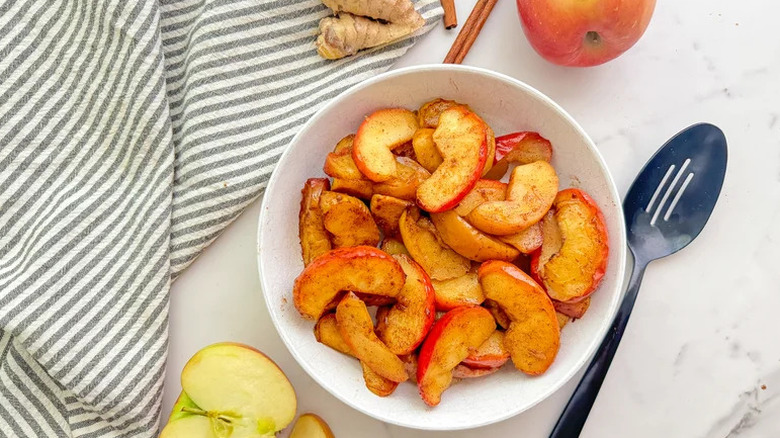 Air Fryer Ginger Cinnamon Apples in white bowl on countertop
