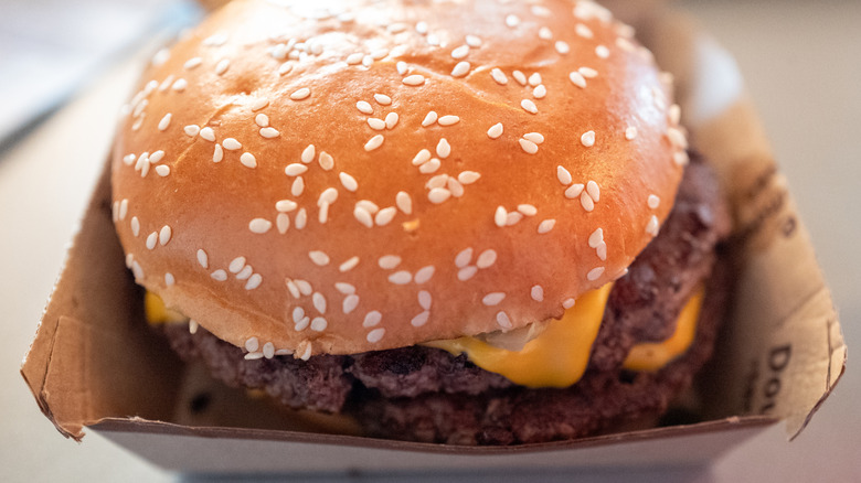 A close-up of a McDonald's Quarter Pounder in a clamshell box