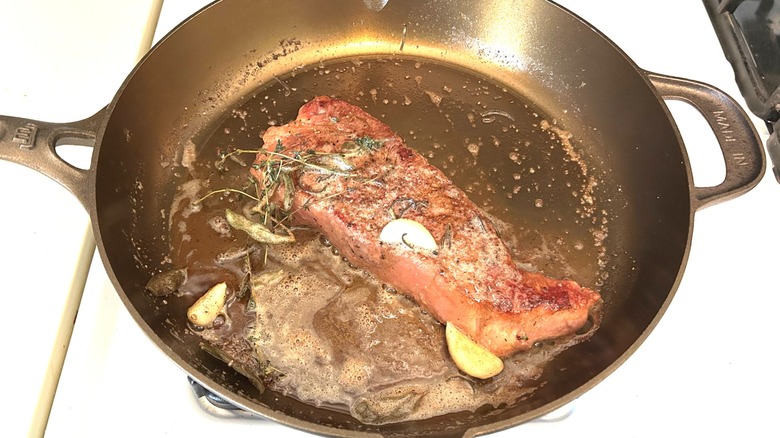 Butter basted strip steak in a Made In Seasoned Cast Iron 12