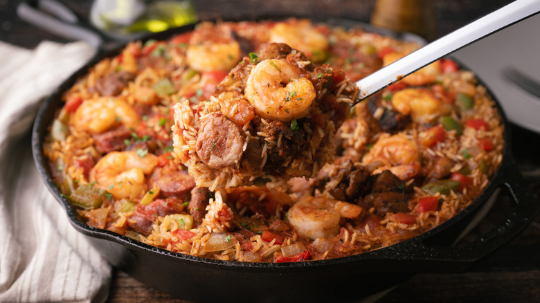 Bowl of jambalaya in a black dish with a spoon