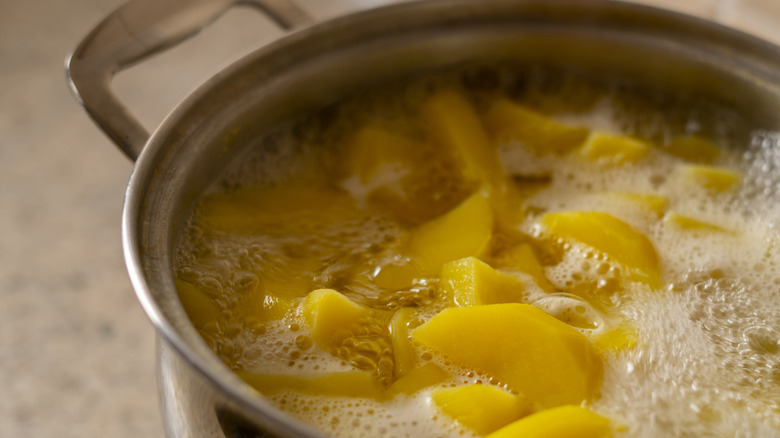 Boiling potato pieces in water
