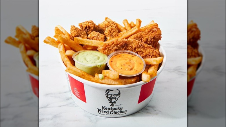 KFC Boneless Bucket for One combo meal with fries, fried chicken, and two cups of dipping sauce