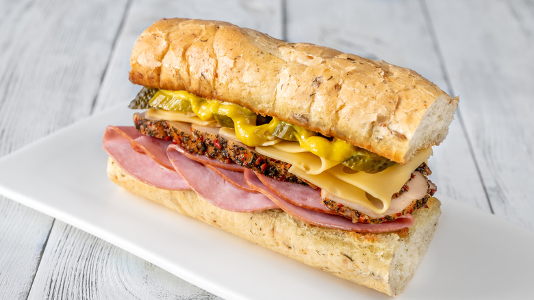 Cuban sandwich on white plate on grey wooden surface