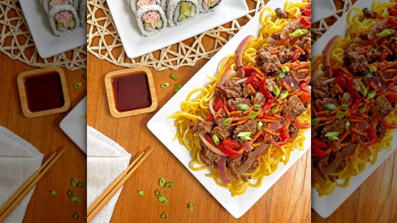 A serving tray of Sam's Club Szechuan noodles with beef and bell peppers