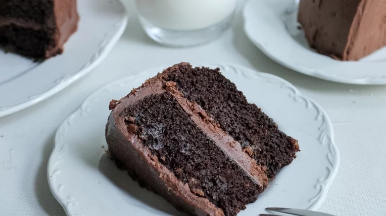 Slice of chocolate layer cake on white plate