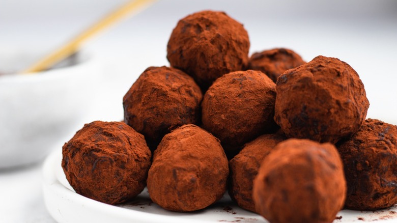 Close-up of chocolate truffles on white plate