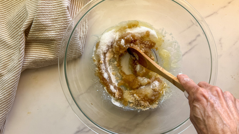 hand stirring sugar and butter in bowl