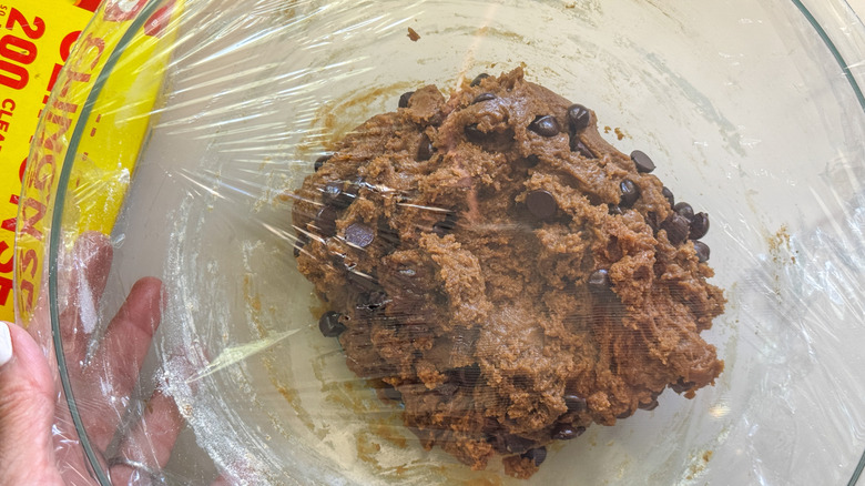 cookie dough in bowl covered with plastic wrap
