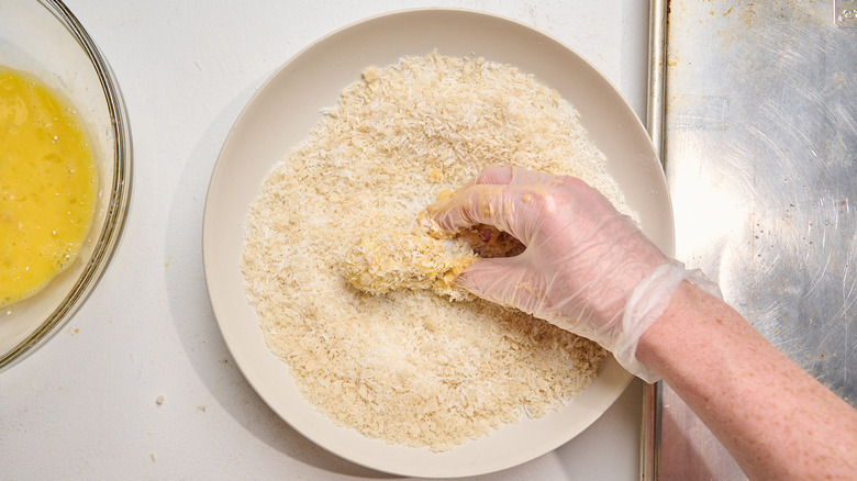 dredging chicken in panko and coconut