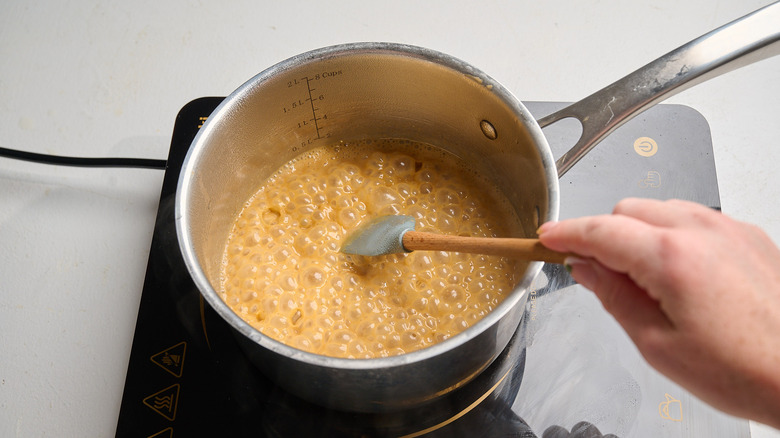 boiling coconut sauce in a saucepan