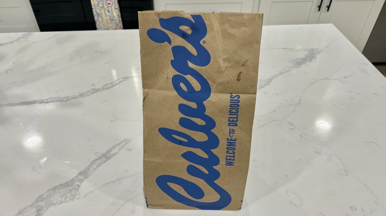 Culver's to-go bag on kitchen counter