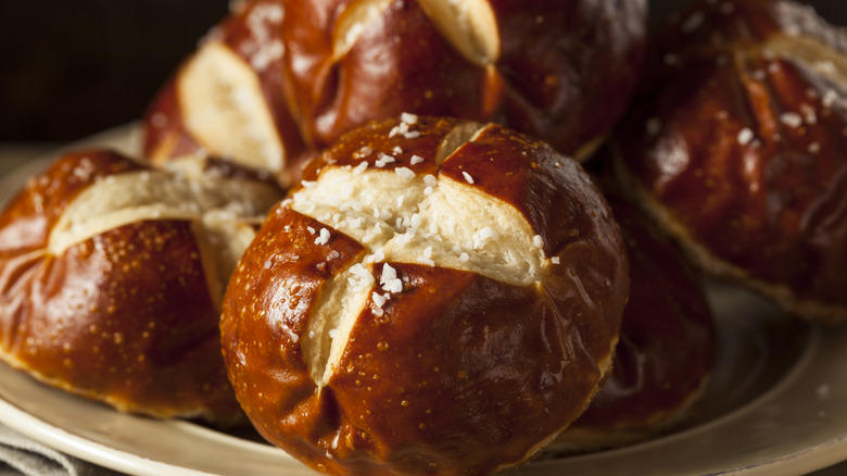 close up of pretzel buns on plate