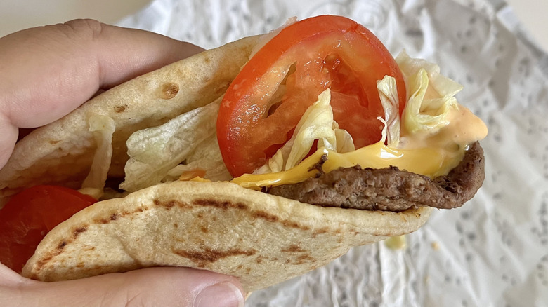 Hand holding  All-American Burgertaco