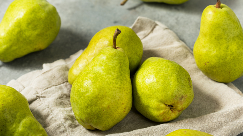 Green Bartlett pears on a cloth napkin