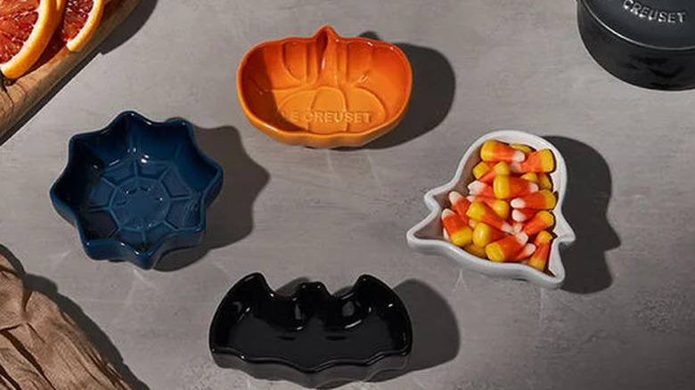 The four Halloween Mini Bowls﻿ on a counter with the ghost filled with candy corn.
