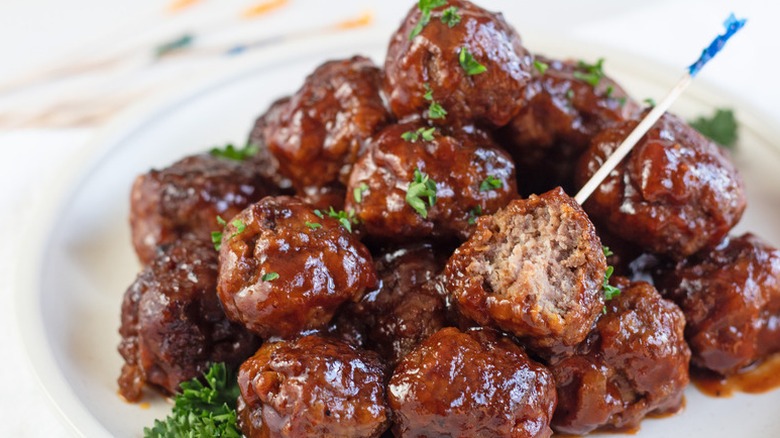 BBQ meatballs on a plate, garnished with fresh parsley