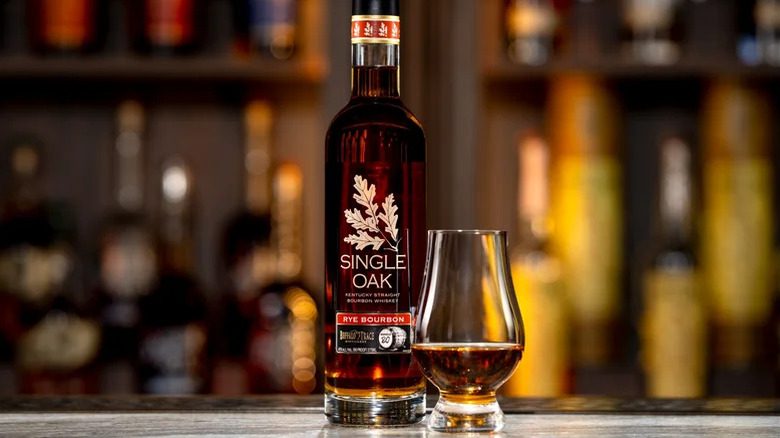 A bottle of Buffalo Trace Distillery Single Oak Barrel 80 Rye Bourbon next to a poured glass
