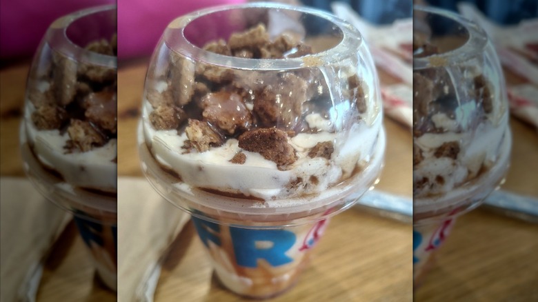 A Wendy's Apple Crumble Frosty Fusion with crumbly bits on top of the ice cream in a Wendy's cup