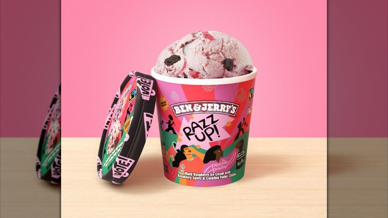 An open pint of Ben & Jerry's Razz Up! ice cream against a pink background