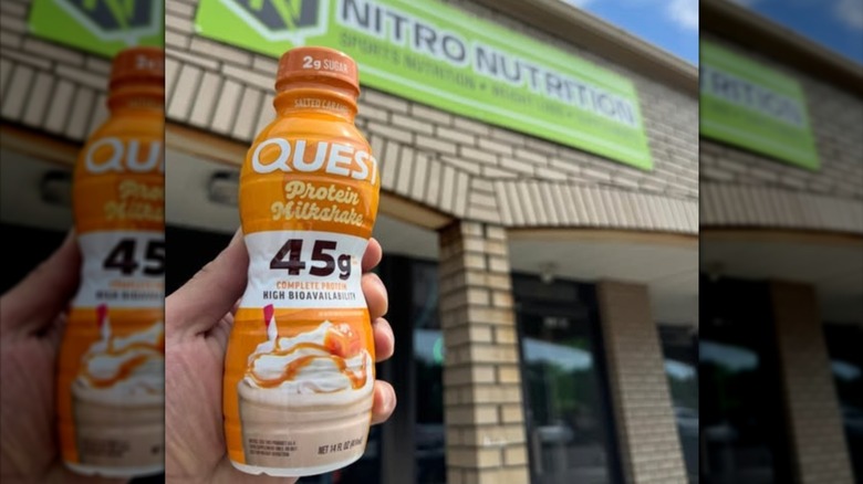 Someone holding a Quest salted caramel protein shake