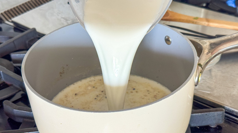Milk pouring into saucepan