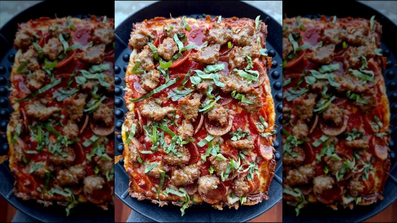 AHoney Badger pizza with pepperoni, fennel sausage, and fresh basil from Pizza Payaa
