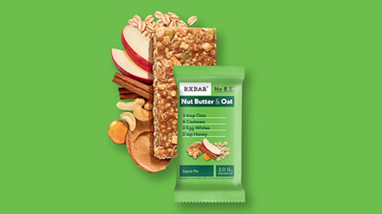 RXBAR Nut Butter & Oats Apple Pie with ingredients against a bright green background.