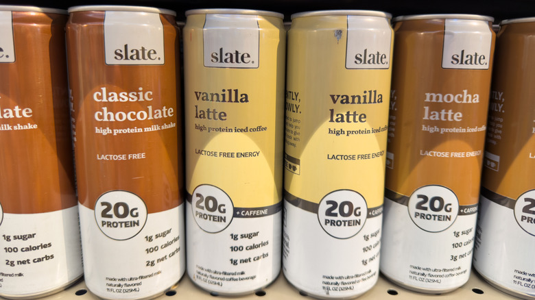 A line up of slate. brand canned protein coffees in a store.