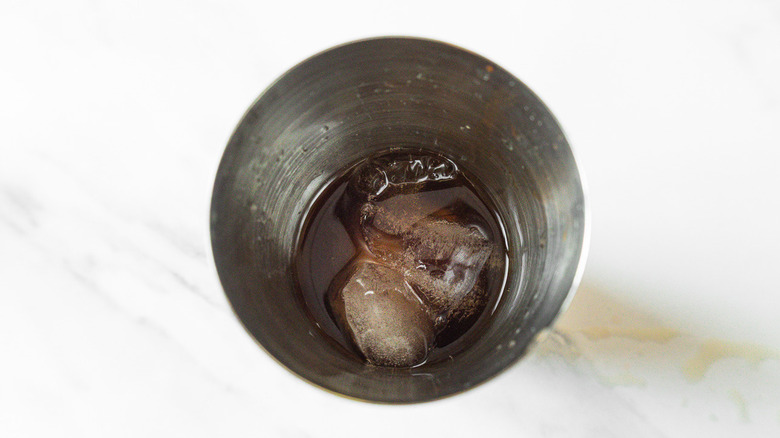 Shaker with ice, rum, lime juice, and bitters.