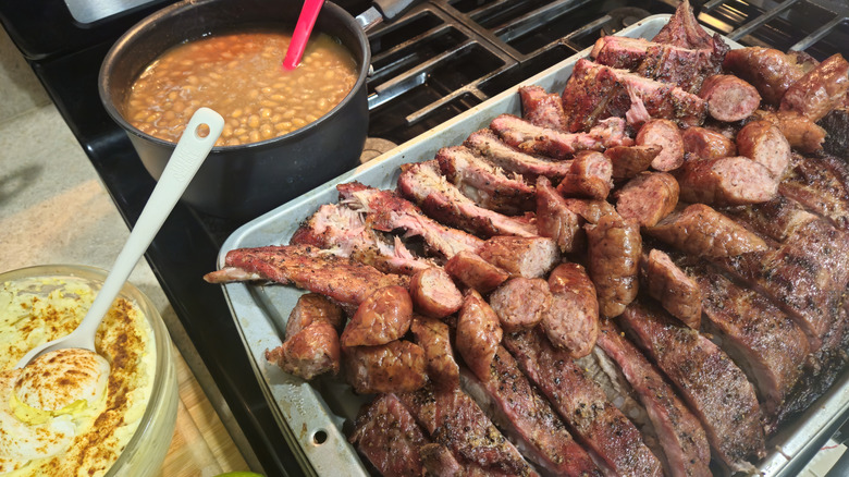 Grilled ribs and sausage with a pot of beans