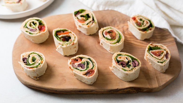 Tomato basil pinwheels on wooden board