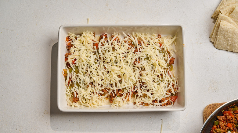 cheese sprinkled over chorizo and salsa