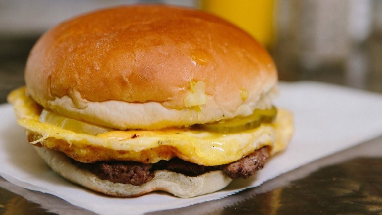 Cheeseburger with bowl of beans