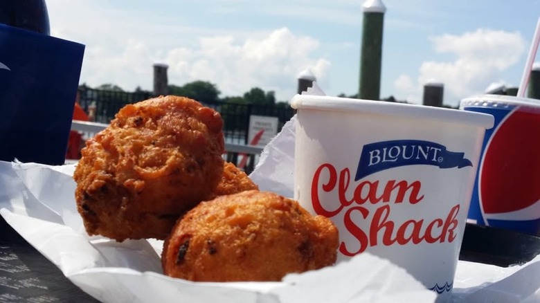 Clam cakes with container for Blount Clam Shack on table outside