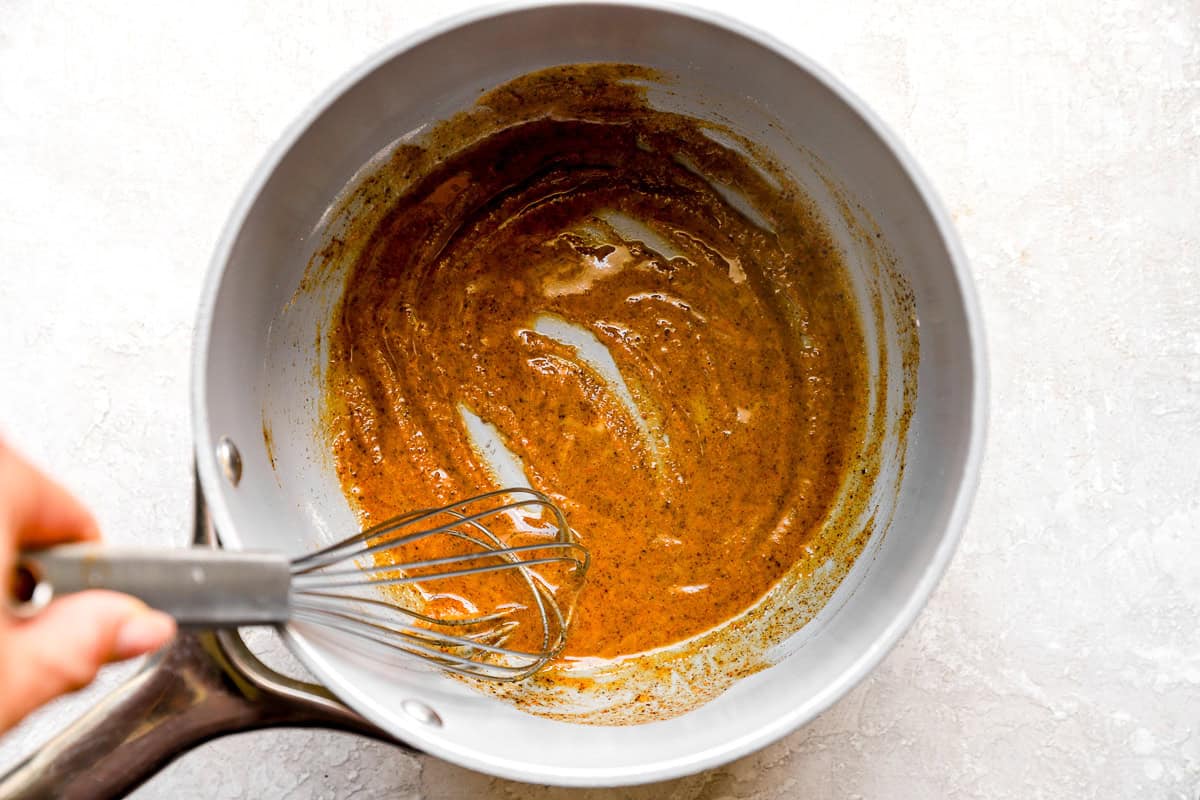 A tightly rolled chimichanga ready to go into the hot oil.