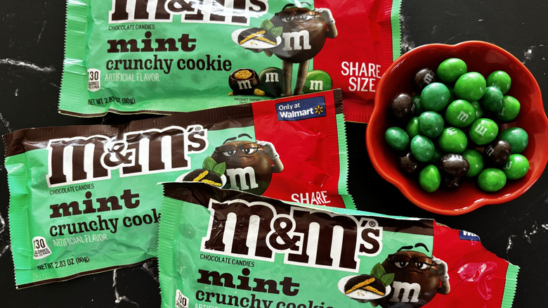 M&M's Mint Crunchy Cookie candy packages with M&M's in bowl