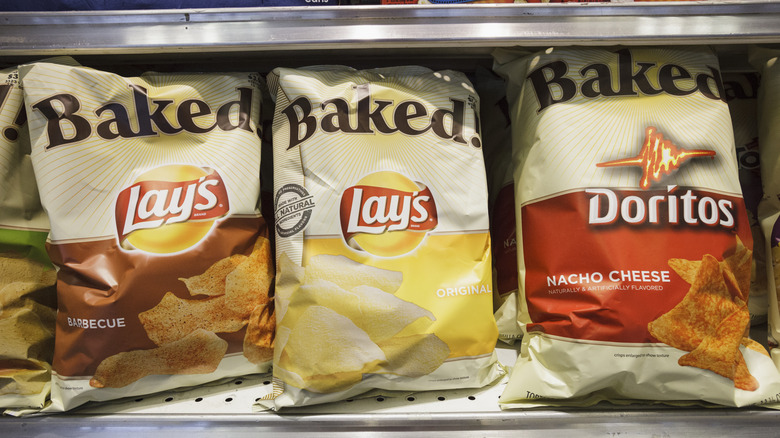 A close up of three bags of Lay's Baked, including Barbeque, Original, and Nacho Cheese.