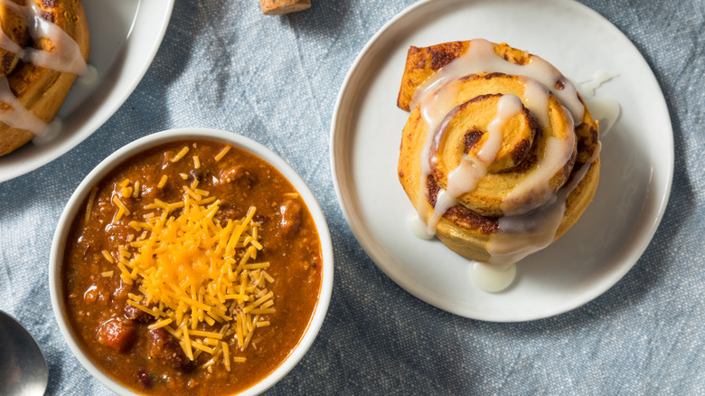 bowl of chili and a cinnamon roll