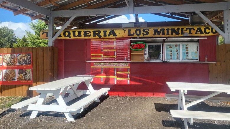 The front of taco trailer with picnic benches