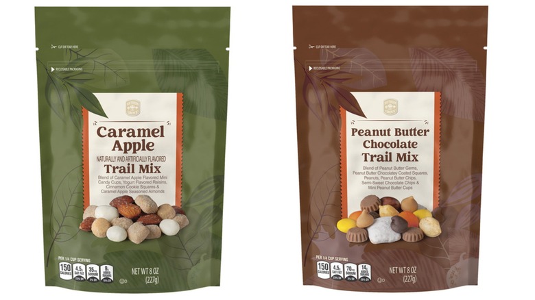 Bags of Aldi's Southern Grove Trail Mix in Caramel Apple and Peanut Butter Chocolate flavors on white background