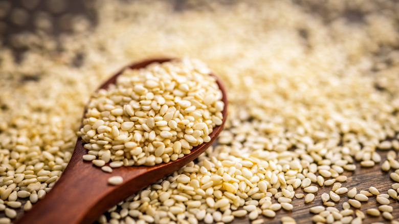 roasted sesame seeds on a wood spoon