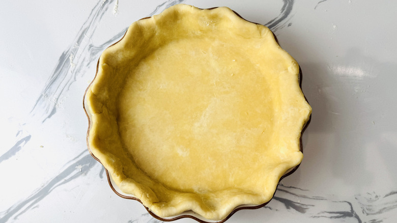 Pie dough crimped in pie plate