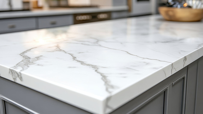 A close up of a white marble countertop with gray veins.