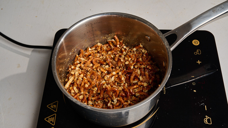 combining pretzels with butter in a saucepan