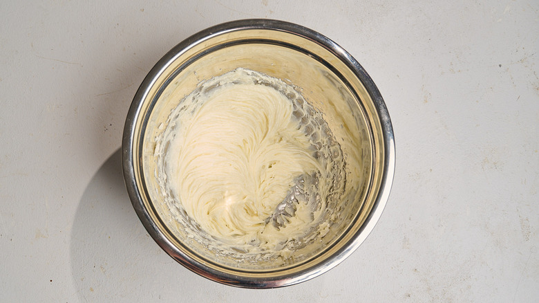 cream cheese beaten with sugar in a bowl