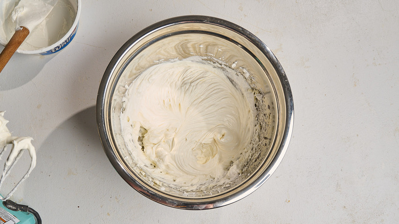 cool whip incorporated into cream cheese in a bowl
