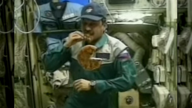 Yuri Usachov eating a Pizza Hut pizza on the International Space Station