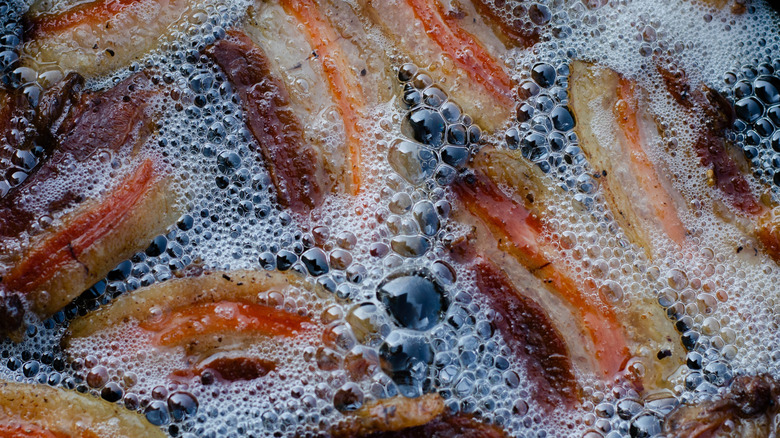 Close-up of bacon frying in bubbling grease